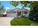 Inviting home featuring stone accents, manicured lawn, and a cozy front porch at 2384 Ponderosa Pl, Erie, CO 80516