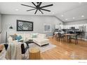 Open living space with hardwood floors, modern furnishings, and vaulted ceilings at 2384 Ponderosa Pl, Erie, CO 80516