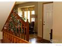 Bright and open foyer with wooden trim and view of a well-lit living area, perfect for a welcoming entrance at 2465 Mapleton Cir, Longmont, CO 80503