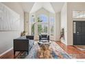 Stylish living room with large windows, hardwood floors, and comfortable seating at 345 Onyx Way, Superior, CO 80027