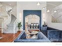 Open concept living room with staircase and view into dining room at 345 Onyx Way, Superior, CO 80027