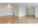 Open living room boasts light walls, hardwood floors, and ample space for various furniture arrangements at 353 S Niagara St, Denver, CO 80224