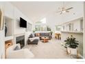 Open-concept living room with fireplace, high ceilings, and adjacent dining area with table at 4887 White Rock Cir # F, Boulder, CO 80301