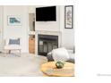 Living room fireplace and mantle, decorative shelving, with plush seating and soft lighting at 4887 White Rock Cir # F, Boulder, CO 80301