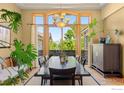 Elegant dining room with scenic views, hardwood floors and custom lighting at 5288 Waterstone Dr, Boulder, CO 80301