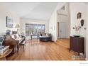 Bright living room with hardwood floors, a vaulted ceiling, and a bay window at 5397 Wild Dunes Ct, Boulder, CO 80301