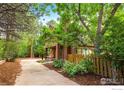 Two-story home surrounded by mature trees, offering a serene and private setting at 701 Kalmia Ave, Boulder, CO 80304