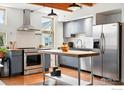 Well-equipped kitchen featuring stainless steel appliances, a center island, and modern finishes at 801 Confidence Dr # 15, Longmont, CO 80504