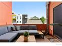 Relaxing patio space with comfortable seating and view of neighborhood architecture at 801 Confidence Dr # 15, Longmont, CO 80504