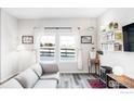 Sunlit living room with a comfortable gray sofa and decorative accents at 897 Winding Brook Dr, Berthoud, CO 80513