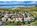 Aerial view of a residential neighborhood near a large lake, showcasing the community's proximity to nature at 10947 W 100Th Dr, Westminster, CO 80021