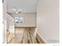 Inviting entryway with wood floors, light-filled space with staircase, and a modern ceiling fan at 14827 Longhorn Dr, Mead, CO 80542