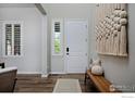Bright foyer with hardwood floors, modern decor, and ample natural light at 15958 Humboldt Peak Dr, Broomfield, CO 80023