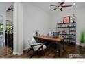 This home office features a modern desk, chair, shelving and hardwood floors at 15958 Humboldt Peak Dr, Broomfield, CO 80023