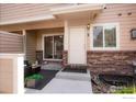 Charming townhome exterior with brick accents, complemented by a well-maintained front entrance and updated features at 1601 Great Western Dr # M2, Longmont, CO 80501
