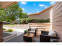 Cozy patio area featuring comfortable seating, a small table, and attractive landscaping, creating a relaxing outdoor space at 1601 Great Western Dr # M2, Longmont, CO 80501