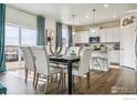 Elegant dining area with modern finishes, blue curtains, and ample natural light at 226 Chardon Ave, Brighton, CO 80601
