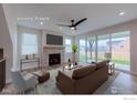 Cozy staged living room featuring a brick fireplace, comfortable seating, and ample natural light at 2397 Bristol St, Superior, CO 80027