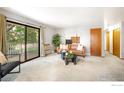 Bright living room with balcony access, stylish furnishings, and neutral decor at 2800 Kalmia Ave # C205, Boulder, CO 80301
