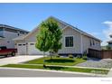 Well-kept home exterior boasting a green lawn, manicured landscaping, and a cozy, inviting ambiance at 2942 Merlin Dr, Brighton, CO 80601
