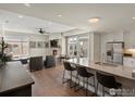Bright, open-concept living room and kitchen area with a fireplace and outdoor access at 3301 Arapahoe Ave # 415, Boulder, CO 80303