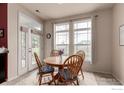 Charming breakfast nook with a round table, four chairs, and bright natural light through large windows at 3577 Molly Cir, Broomfield, CO 80023