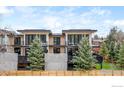 Modern townhomes with private balconies and patios, complemented by lush greenery at 358 Arapahoe Ave # B, Boulder, CO 80302