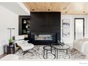 Modern living room with a black fireplace, open shelving, and stylish decor at 358 Arapahoe Ave # B, Boulder, CO 80302