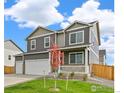 New home with a three-car garage, attractive landscaping, and a charming covered front porch at 4331 Gypsum Ave, Mead, CO 80504