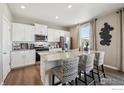 Kitchen featuring stainless steel appliances, granite countertops, and a kitchen island with barstool seating at 4331 Gypsum Ave, Mead, CO 80504