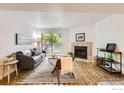 Cozy living room with a fireplace, sliding glass doors to a balcony, and stylish decor at 4670 White Rock Cir # 1, Boulder, CO 80301