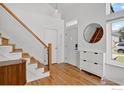 Bright foyer featuring hardwood floors, modern staircase and a coat rack at 4926 Pasadena Way, Broomfield, CO 80023