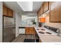 Functional kitchen featuring light wood cabinets, white appliances, and durable countertops at 51 21St Ave # 43, Longmont, CO 80501