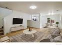 Bright living room featuring hardwood floors, modern furnishings, and an open layout at 5225 E 100Th Dr, Thornton, CO 80229