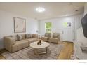 Cozy living room with modern furniture, area rug, and white walls at 5225 E 100Th Dr, Thornton, CO 80229
