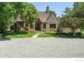 Charming stone home with well-maintained landscaping and mature trees on a large lot at 5575 Saint Vrain Rd, Longmont, CO 80503