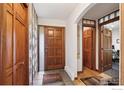 Inviting entryway with wood accents and tiled flooring at 7290 Mount Sherman Rd, Longmont, CO 80503