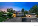 Stunning modern home with a large driveway, a well-manicured lawn, and an attached garage at 7451 Rozena Dr, Longmont, CO 80503