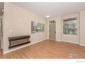 Cozy living room featuring an electric fireplace, neutral paint, and bright natural light at 829 Kane Dr # 23, Longmont, CO 80501
