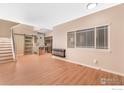 Bright living room with wood floors, electric fireplace, and an open kitchen area at 829 Kane Dr # 23, Longmont, CO 80501