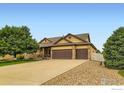 Lovely home with a spacious driveway, a three-car garage, and mature landscaping at 9629 Bountiful St, Firestone, CO 80504