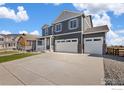 Attractive two-story home featuring a two-car garage, covered porch, and extended driveway at 1038 Scotts Peak Dr, Berthoud, CO 80513