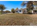 Well-maintained single-story home with large front yard and mature trees, offering ample outdoor space at 1109 Ironton St, Aurora, CO 80010