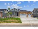 Attractive single-story home featuring a stone facade and a three-car garage at 1144 Ridgefield Dr, Berthoud, CO 80513