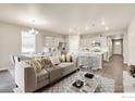 Open-concept living area featuring a modern kitchen and dining space at 1144 Ridgefield Dr, Berthoud, CO 80513