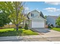 Beautiful two-story home with a well-manicured lawn and a two car attached garage at 1506 Crestwood Cir, Longmont, CO 80504