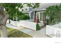 Charming home with a front patio, white picket fence, and mature trees at 154 Blue Spruce Ct, Highlands Ranch, CO 80126