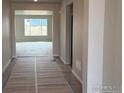 The entryway offers a view into the spacious living room and abundant natural light at 1713 Jennifer St, Brighton, CO 80601