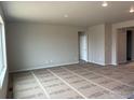 Bright and spacious living room with large windows and neutral paint, ready for personalization at 1713 Jennifer St, Brighton, CO 80601