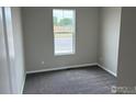 Bedroom featuring neutral walls, carpet, and a window with natural light at 1759 Jennifer St, Brighton, CO 80601